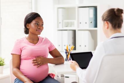 Pregnant patient at a checkup with their doctor